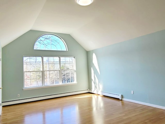 89 Railroad Ave, Center Moriches, NY 11934 - unfurnished living room with baseboards, wood finished floors, vaulted ceiling, and baseboard heating