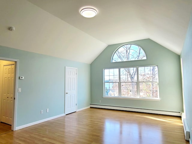 89 Railroad Ave, Center Moriches, NY 11934 - interior space with lofted ceiling, a baseboard heating unit, baseboards, a baseboard radiator, and wood finished floors