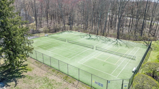 view of sport court featuring fence
