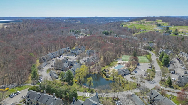 birds eye view of property featuring a water view and a view of trees