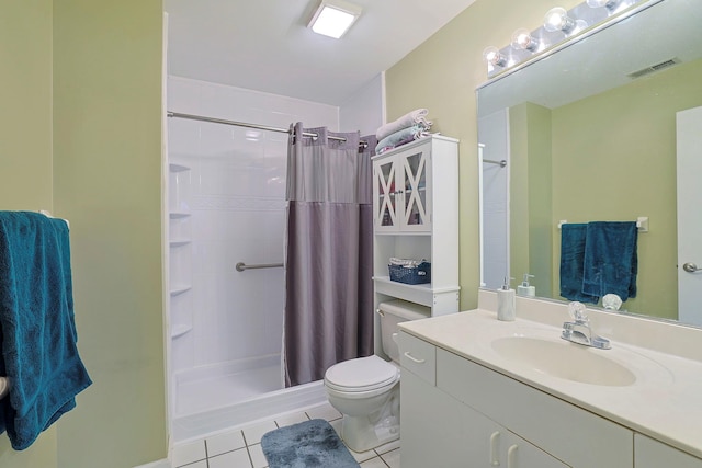 bathroom featuring toilet, vanity, visible vents, tile patterned floors, and a tile shower