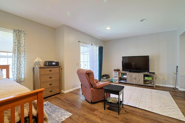 living room with recessed lighting, baseboards, a healthy amount of sunlight, and wood finished floors