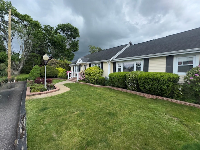 524 Polaris St, North Babylon, NY 11703 - view of property exterior featuring a yard and a shingled roof