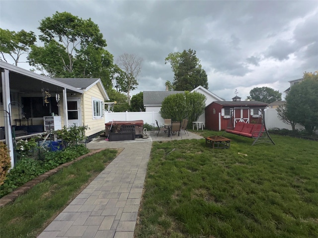 524 Polaris St, North Babylon, NY 11703 - view of yard with a hot tub, a patio, a fire pit, and an outbuilding