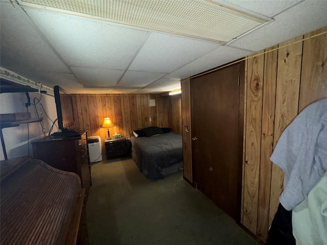 524 Polaris St, North Babylon, NY 11703 - bedroom with wood walls, carpet, and a drop ceiling