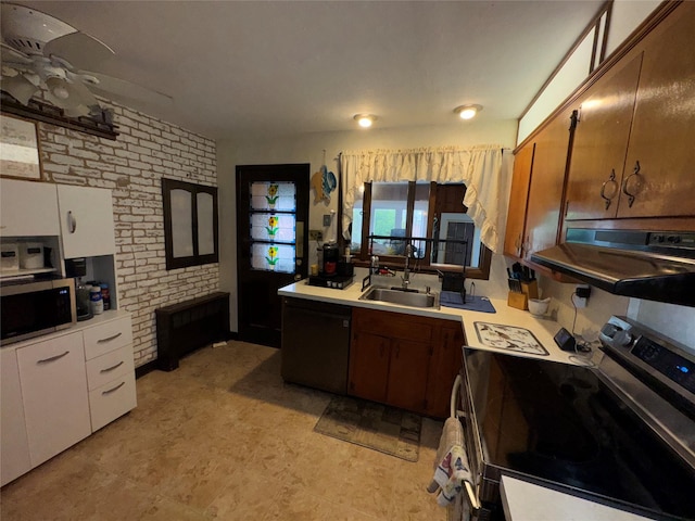 524 Polaris St, North Babylon, NY 11703 - kitchen with appliances with stainless steel finishes, a sink, light countertops, brick wall, and radiator heating unit