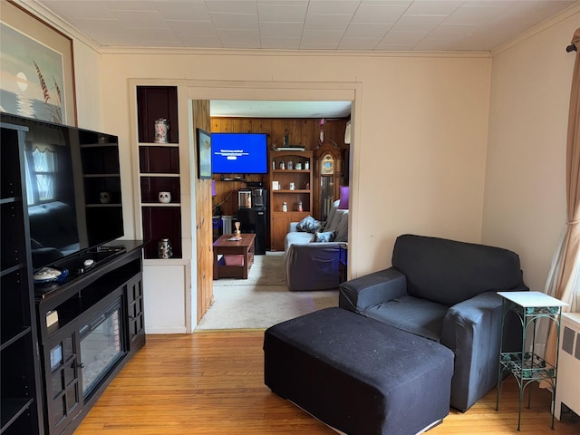 524 Polaris St, North Babylon, NY 11703 - living area with crown molding, wood finished floors, and radiator heating unit