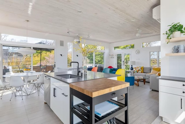 267 Floral Walk, Fire Island Pines, NY 11782 - kitchen with white cabinetry, french doors, a sink, wood counters, and dishwasher