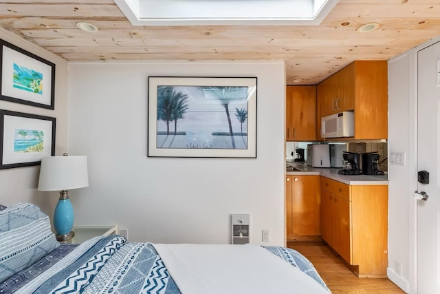 267 Floral Walk, Fire Island Pines, NY 11782 - bedroom with wood ceiling, a skylight, light wood-style floors, and recessed lighting