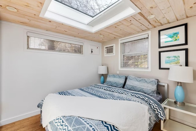 267 Floral Walk, Fire Island Pines, NY 11782 - bedroom with a wall mounted air conditioner, baseboards, wood finished floors, lofted ceiling, and wooden ceiling