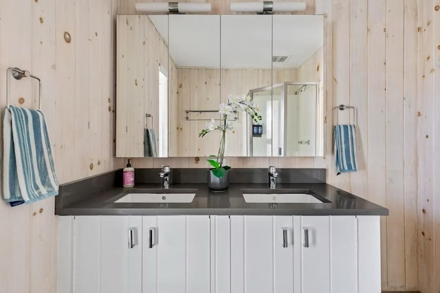 267 Floral Walk, Fire Island Pines, NY 11782 - bathroom with a stall shower, double vanity, visible vents, and a sink