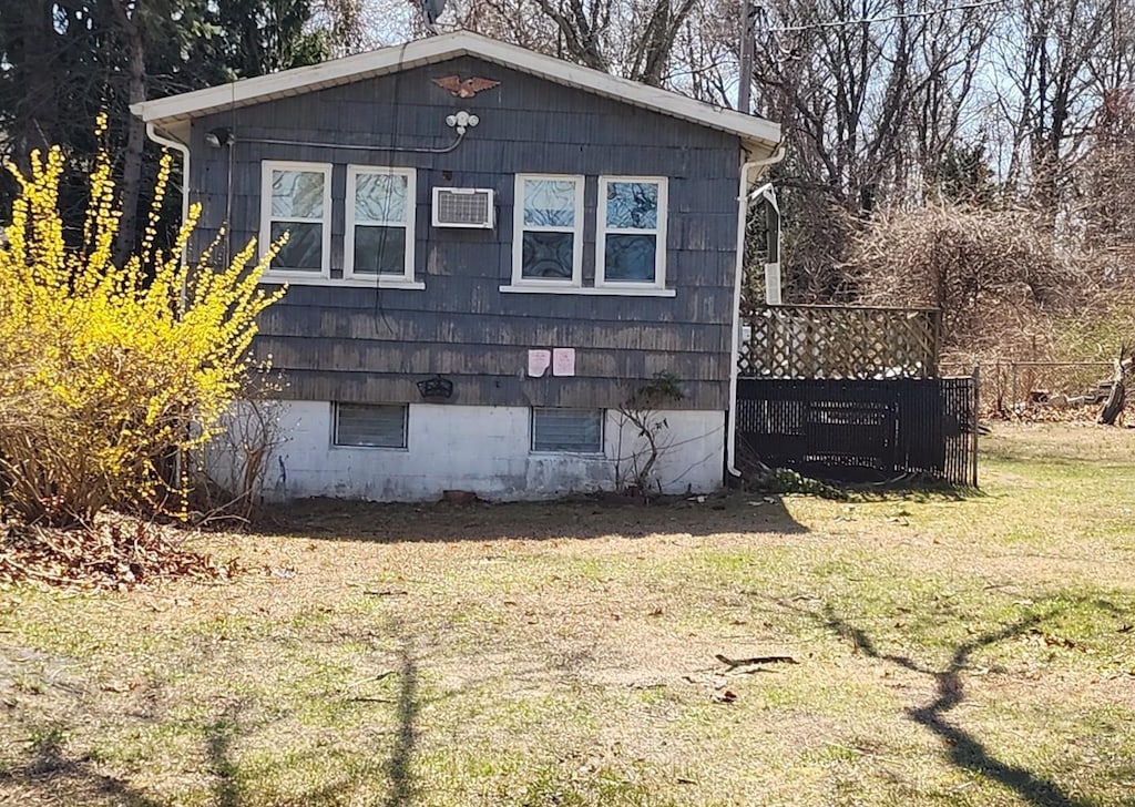 44 Osage St, Selden, NY 11784 - view of side of home with a wall mounted air conditioner and a lawn