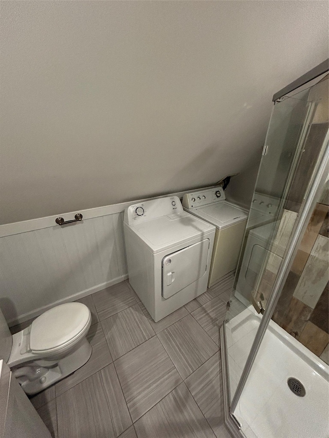 22 Peacock Ln, Levittown, NY 11756 - bathroom with toilet, tile patterned floors, a stall shower, washing machine and dryer, and wainscoting
