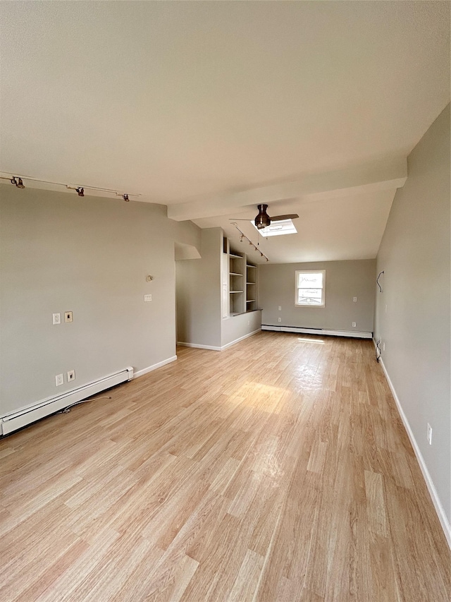 22 Peacock Ln, Levittown, NY 11756 - unfurnished living room with baseboards, ceiling fan, light wood-style flooring, and a baseboard heating unit