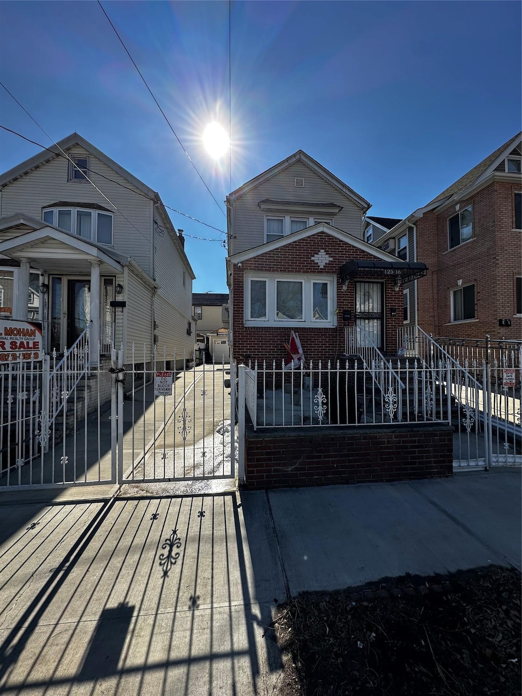 view of front of property with brick siding and a fenced front yard