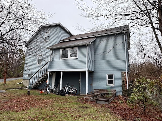 back of property featuring stairs