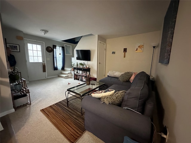 carpeted living room with baseboards