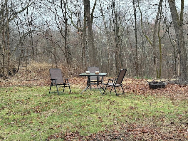 view of yard featuring a forest view