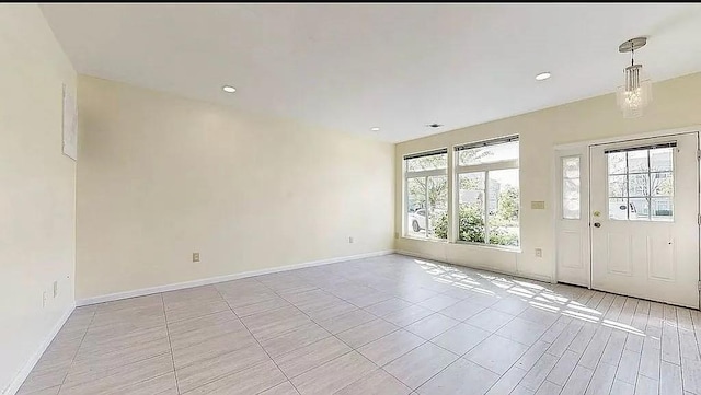 foyer with baseboards, light tile patterned floors, and recessed lighting