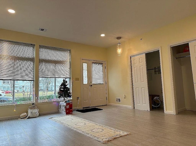 entryway featuring baseboards and recessed lighting