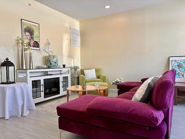 living area with a fireplace and recessed lighting
