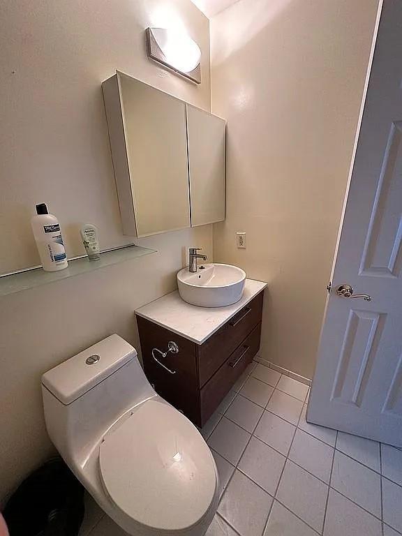 bathroom featuring tile patterned floors, vanity, and toilet