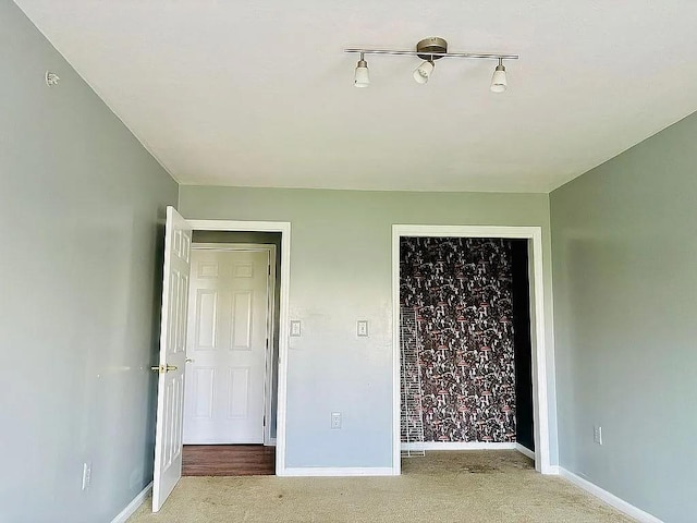 unfurnished bedroom featuring carpet flooring, baseboards, and a closet