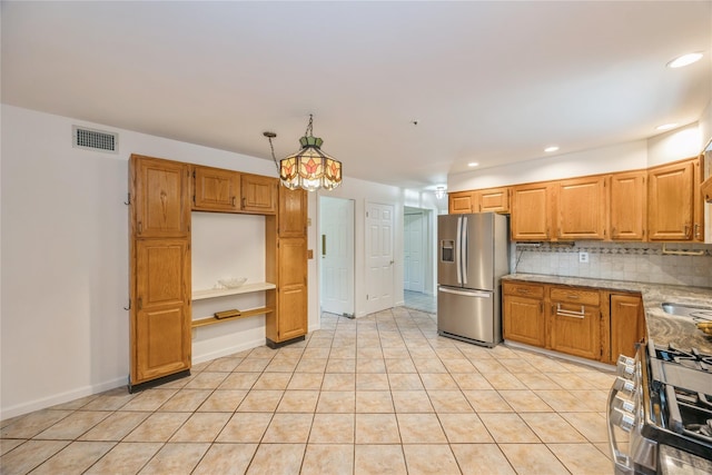 3 Benjamin Ct, Ardsley, NY 10502 - kitchen with stainless steel appliances, decorative backsplash, light stone counters, light tile patterned floors, and a sink
