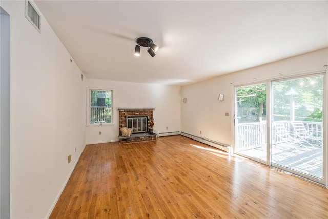 3 Benjamin Ct, Ardsley, NY 10502 - unfurnished living room with a baseboard heating unit, light wood-type flooring, a fireplace, and baseboards