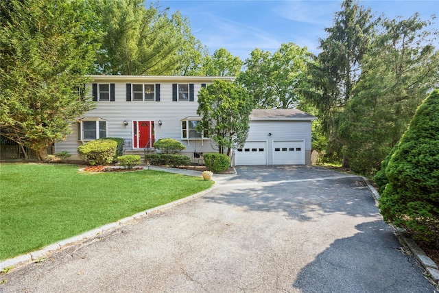 3 Benjamin Ct, Ardsley, NY 10502 - colonial-style house with driveway, a front lawn, and an attached garage