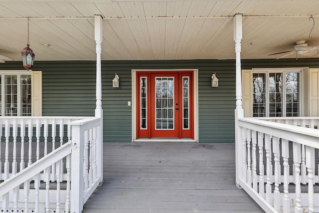 doorway to property featuring a ceiling fan and covered porch