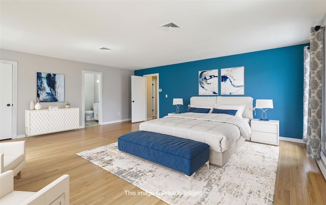 bedroom featuring visible vents and wood finished floors