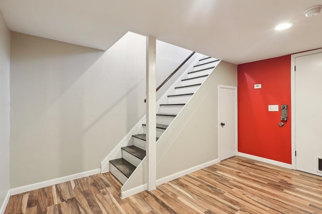 interior space with baseboards, recessed lighting, and wood finished floors