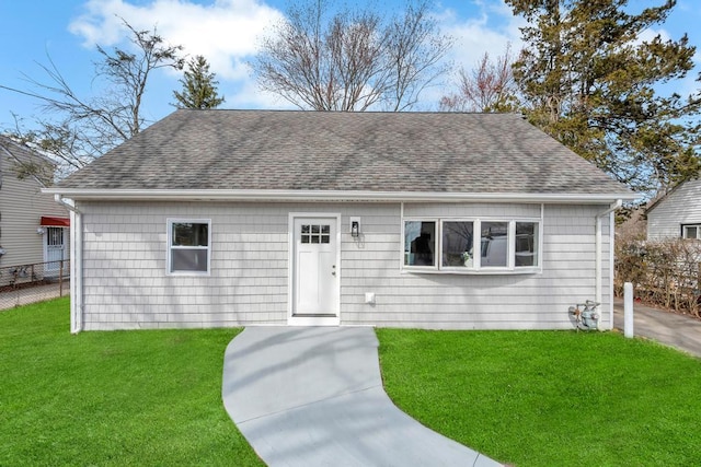 81 New Ave, Wyandanch, NY 11798 - ranch-style home with a front lawn, fence, and roof with shingles
