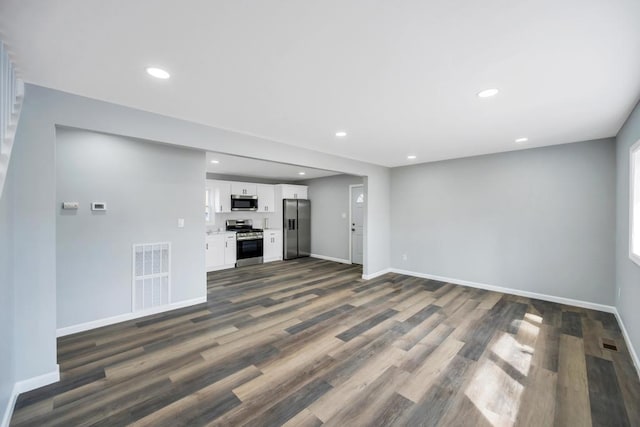 81 New Ave, Wyandanch, NY 11798 - unfurnished living room featuring dark wood finished floors, recessed lighting, baseboards, and visible vents