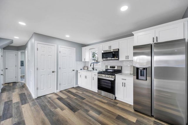81 New Ave, Wyandanch, NY 11798 - kitchen with dark wood-style flooring, light countertops, a sink, and appliances with stainless steel finishes