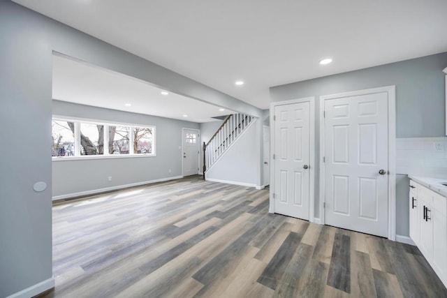 81 New Ave, Wyandanch, NY 11798 - below grade area with stairs, recessed lighting, wood finished floors, and baseboards