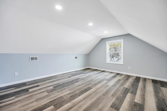 81 New Ave, Wyandanch, NY 11798 - additional living space with baseboards, visible vents, vaulted ceiling, and wood finished floors
