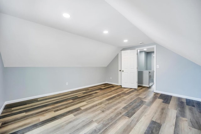 81 New Ave, Wyandanch, NY 11798 - additional living space with recessed lighting, baseboards, vaulted ceiling, and wood finished floors