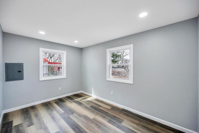 81 New Ave, Wyandanch, NY 11798 - unfurnished room featuring electric panel, baseboards, plenty of natural light, and dark wood-style flooring
