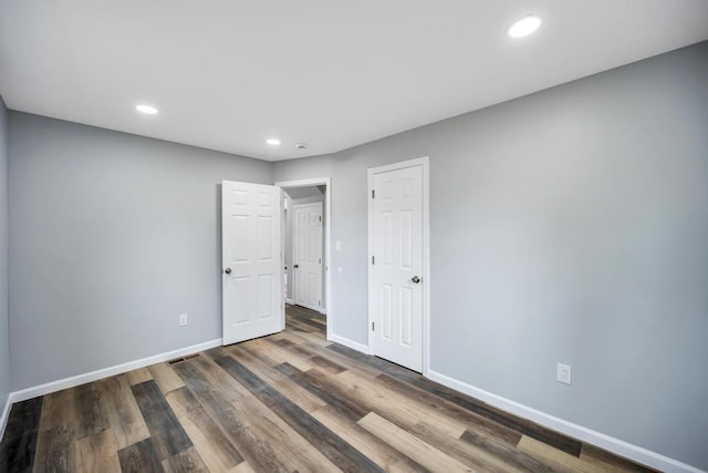 81 New Ave, Wyandanch, NY 11798 - unfurnished bedroom featuring baseboards, wood finished floors, and recessed lighting