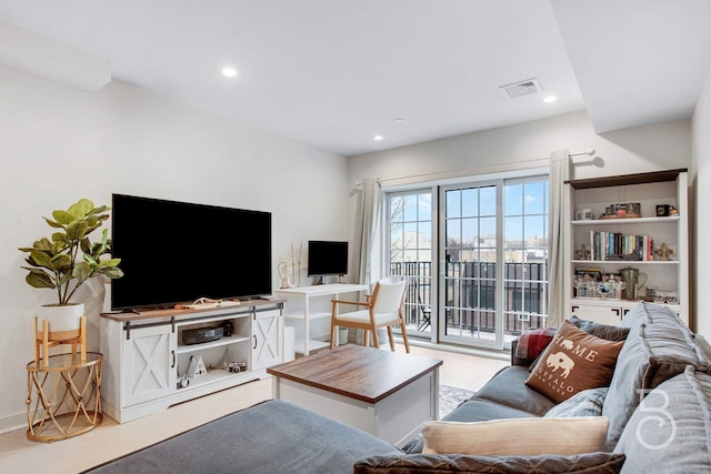 living room featuring light wood-style flooring and recessed lighting