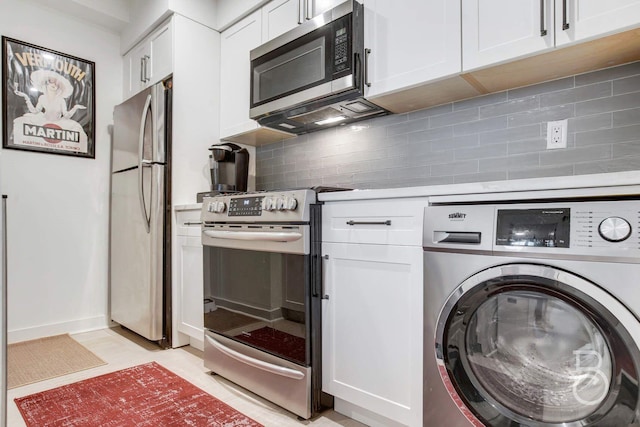 kitchen featuring washer / clothes dryer, stainless steel appliances, white cabinetry, and decorative backsplash