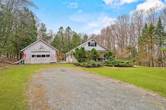 53 Dill Rd, Forestburgh, NY 12777 - view of front facade featuring driveway, an outbuilding, a garage, a front lawn, and a porch