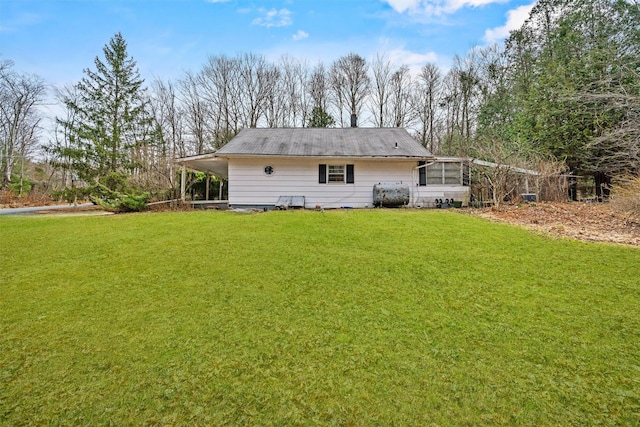 53 Dill Rd, Forestburgh, NY 12777 - back of house with heating fuel and a lawn