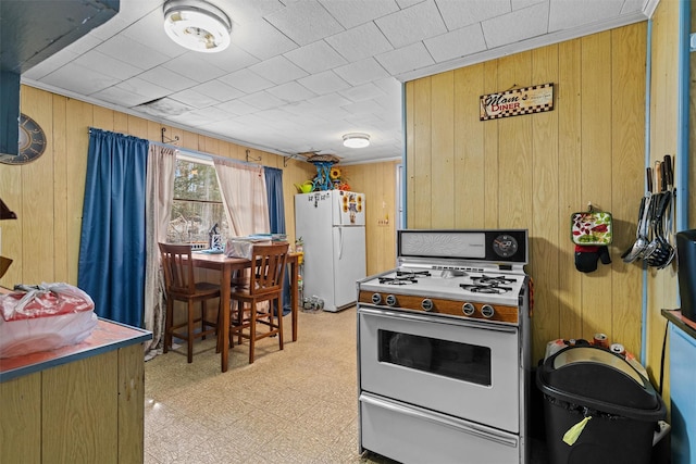 53 Dill Rd, Forestburgh, NY 12777 - kitchen featuring light floors, wooden walls, and white appliances