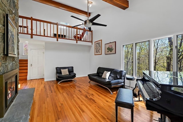 living area featuring plenty of natural light, a high ceiling, and a fireplace