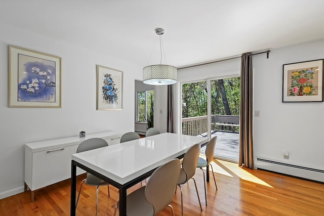 dining area with baseboard heating and wood finished floors