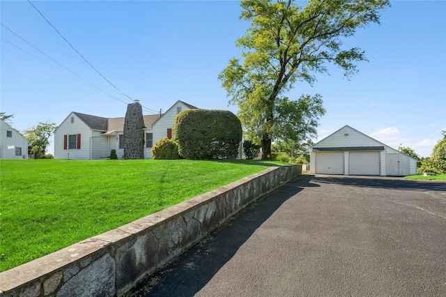 100 S Fairview Ave, Montauk, NY 11954 - view of home's exterior featuring a lawn, a detached garage, and an outdoor structure