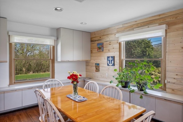 100 S Fairview Ave, Montauk, NY 11954 - dining area with recessed lighting, wooden walls, dark wood-type flooring, and a healthy amount of sunlight